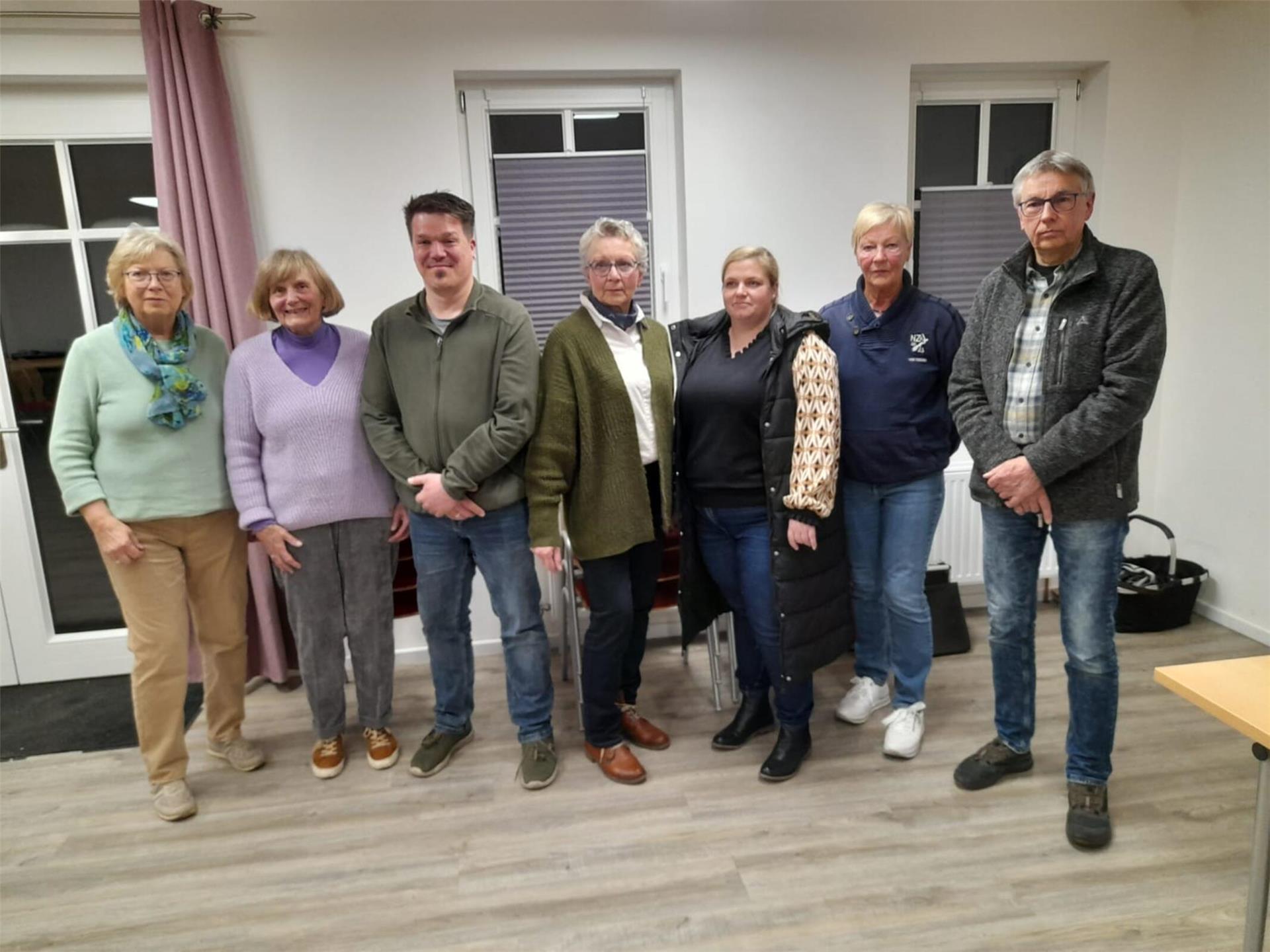 Eine Gruppe Frauen und Männer blickt in die Kamera.