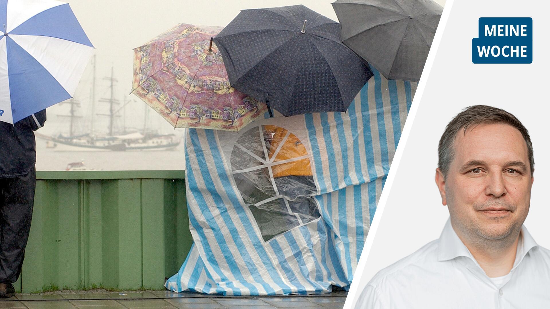 Menschen schützen sich mit Schirmen und Planen vor Regen, im Hintergrund ein Segelschiff.