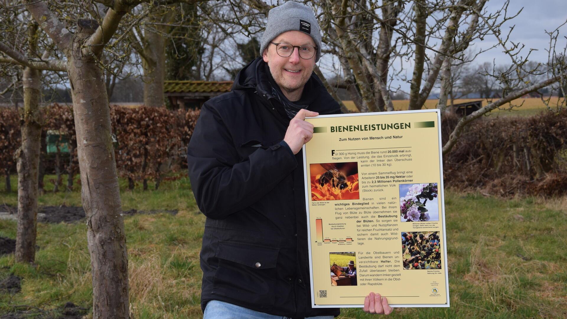 Der Selsinger Imkervereins-Vorsitzende Kai Oevermann präsentiert eines der Schilder mit Informationen.