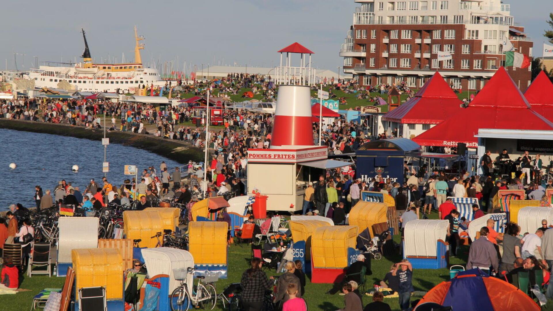 Viele Menschen tummeln sich in Strandkörben an der Grimmershörner Bucht in Cuxhaven. 