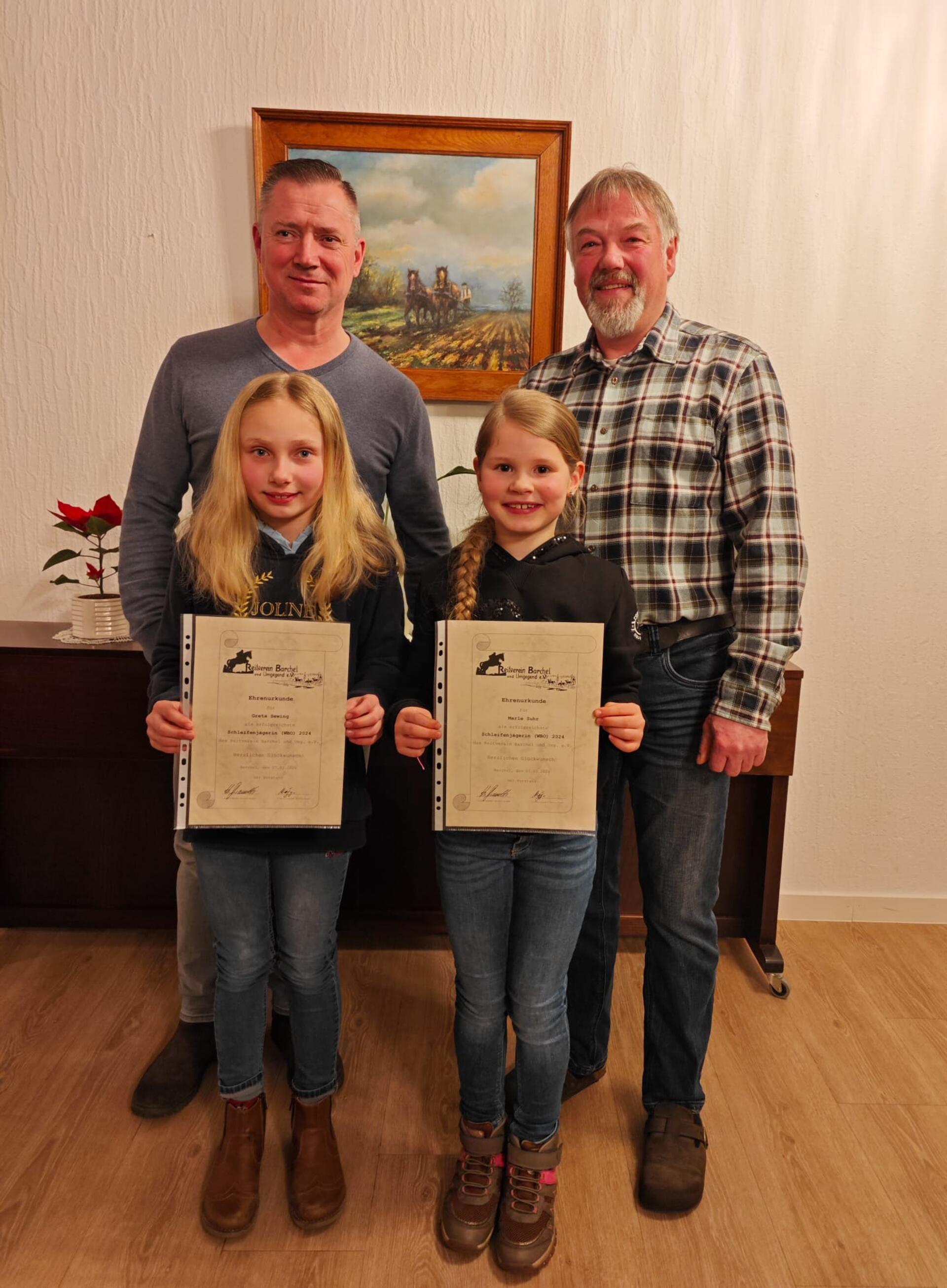 Der erste Vorsitzende des Reitvereins Barchel, Holger Brandt (rechts), und der zweite Vorsitzende Stefan Mügge mit den erfolgreichen Schleifenjägerinnen Greta Sewing (links) und Marle Suhr (rechts).