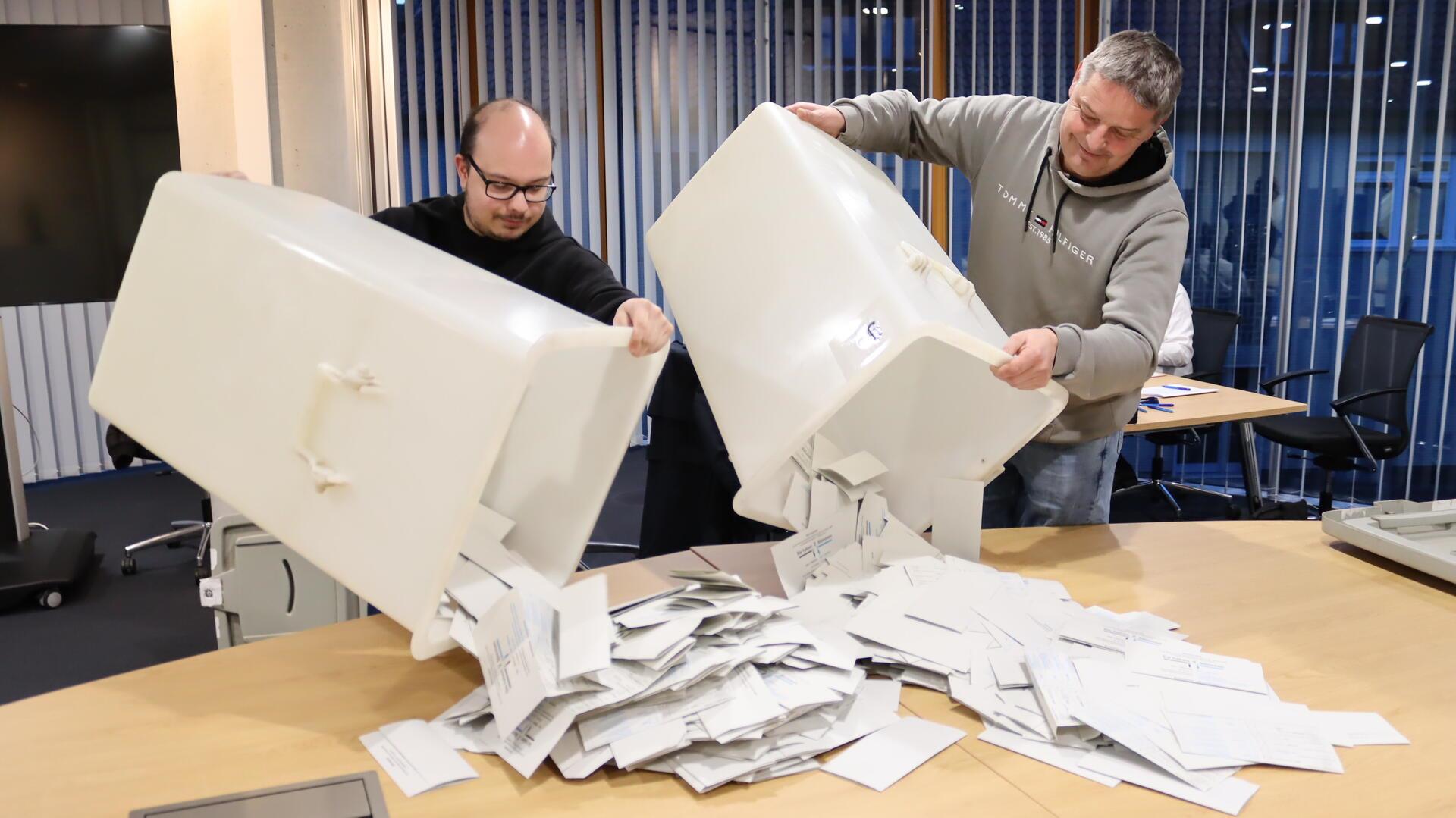 Wahlhelfende öffnen und leeren die Wahlurne im Wahllokal der Stadtwerke Zeven nach der Bundestagswahl.