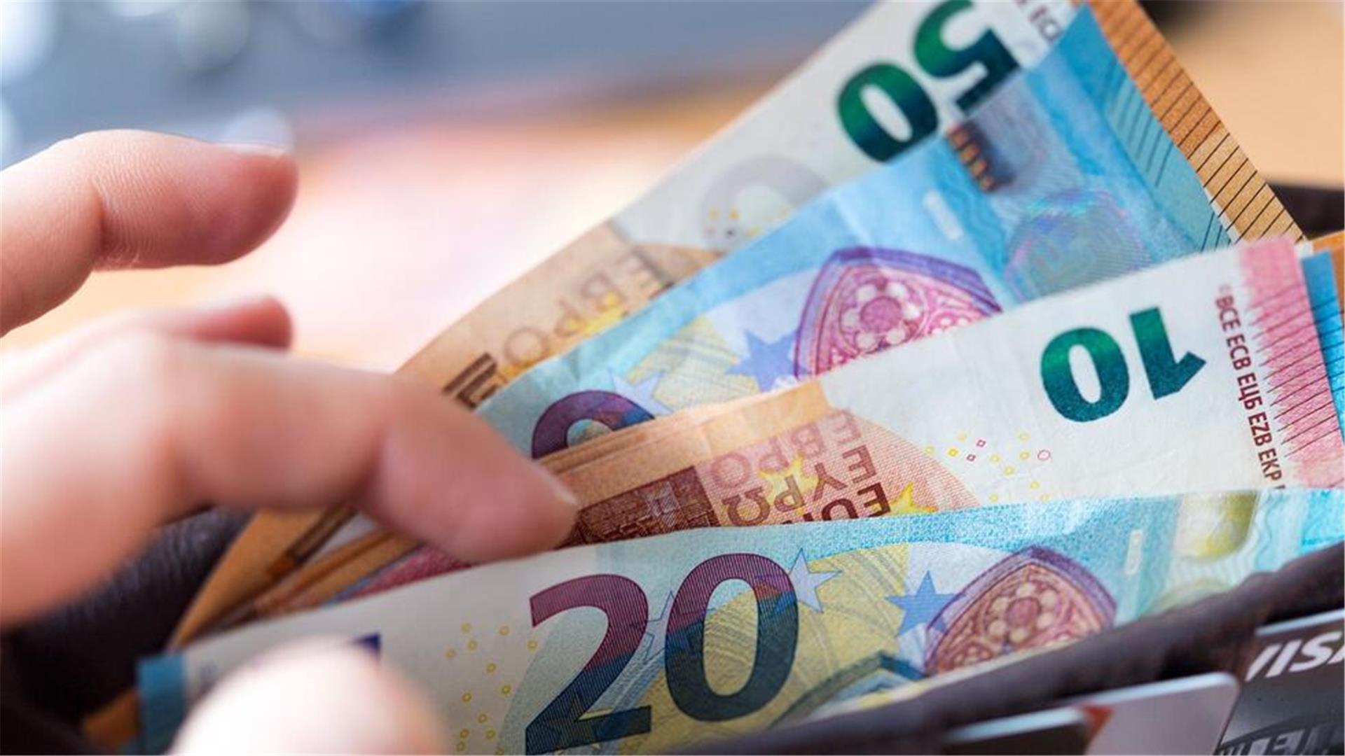 Eine Hand hält Geldscheine.