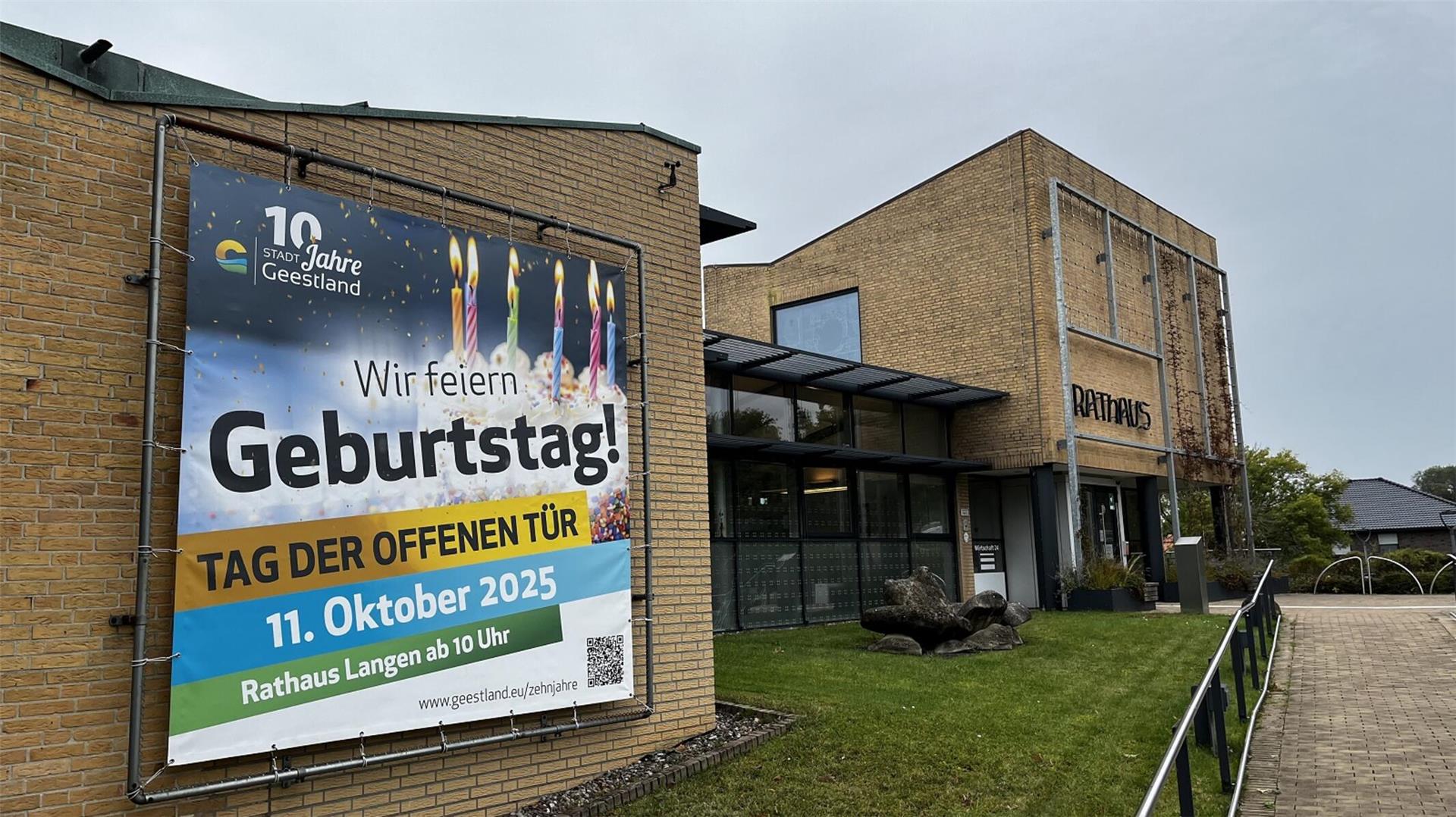 Außenansicht des Rathauses Langen in Geestland mit großem Banner an der Fassade, das auf den „Tag der offenen Tür“ am 11. Oktober 2025 zum zehnjährigen Stadtjubiläum hinweist.