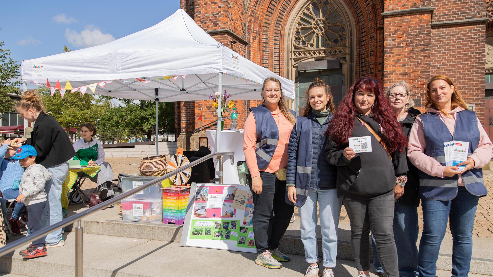 Frauen vor einer Kirche blicken in die Kamera. 