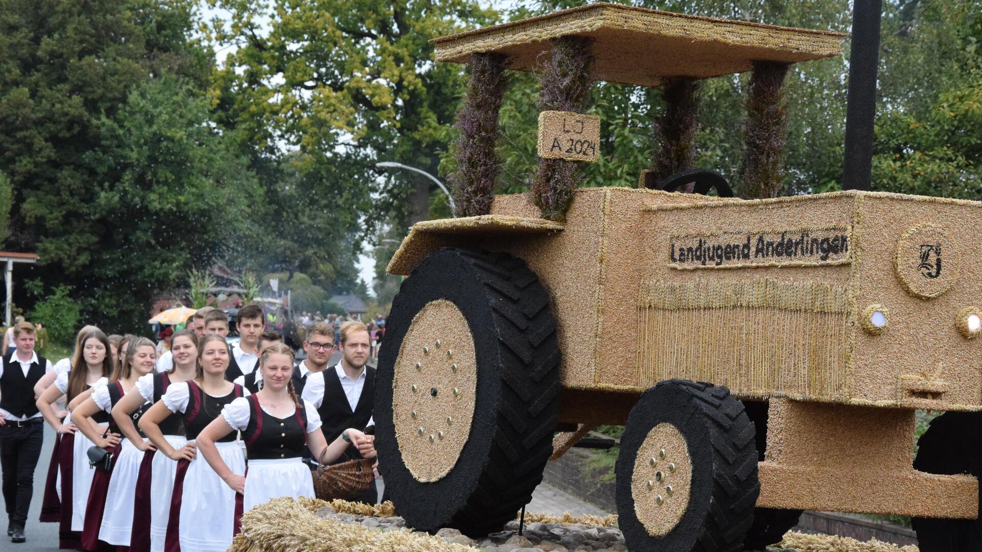 Landjugend Anderlingen in Tracht hinter einem Erntewagen.