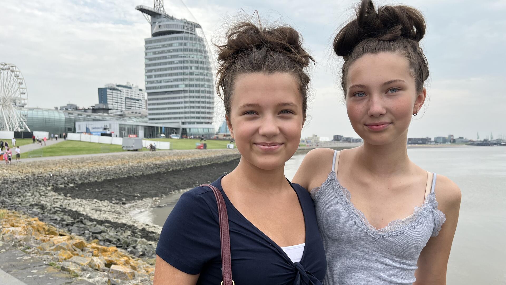 Zwei junge Mädchen vor dem Atlantic Hotel Sail City. 