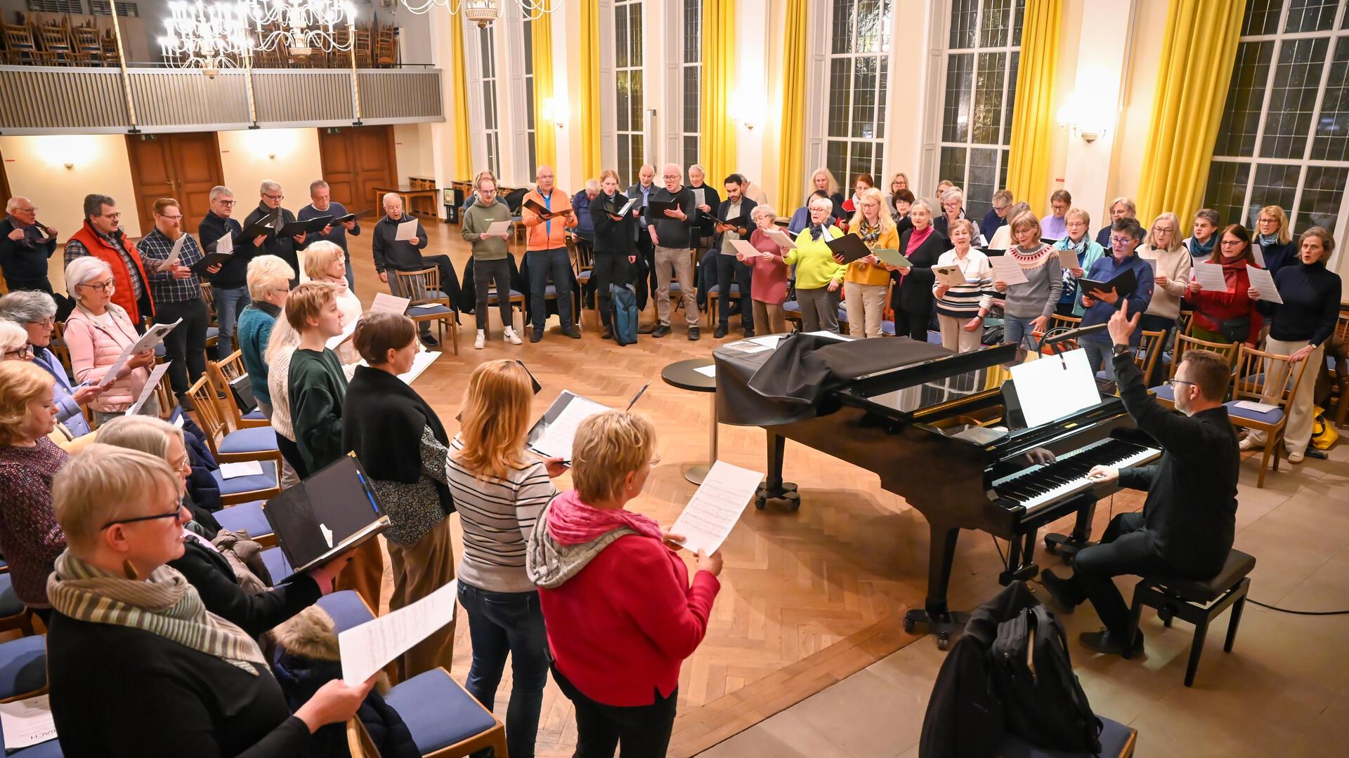 Noch wird im Gemeindesal geprobt: Bremens Landeskirchenmusikdirektor David Schollmeyer führt am 23. März in der "Großen Kirche" in Bremerhaven ein besonderes Passionskonzert auf, Hauptwerk ist eine Bach-Kantate nach Pergolesis Stabat Mater in neuer Fassung für vierstimmigen Chor.