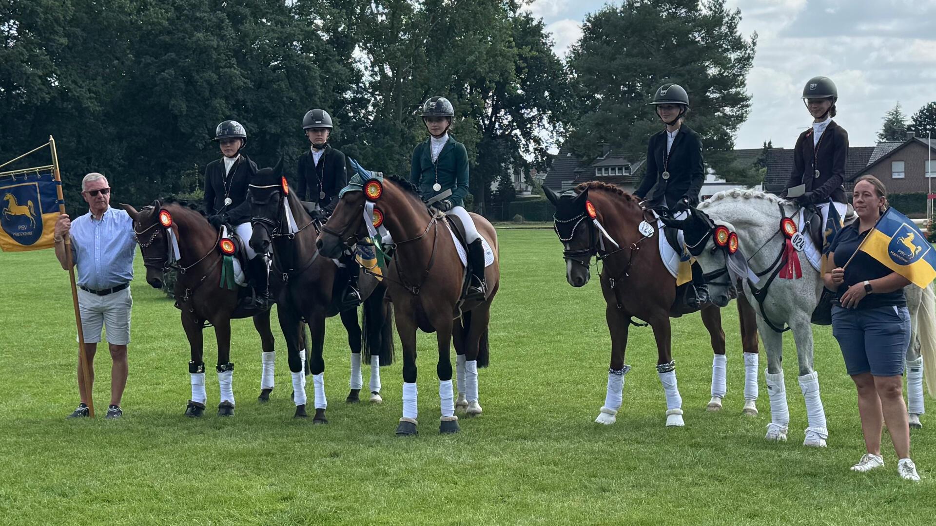 Über die Silbermedaille der Ponyreiterinnen freuen sich (von links): Landestrainer Claus Erhorn, Lisa von Helldorff, Lina Schütz, Lina Quast, Lenja Reitmann, Anna von Helldorff und Christin Tidow.