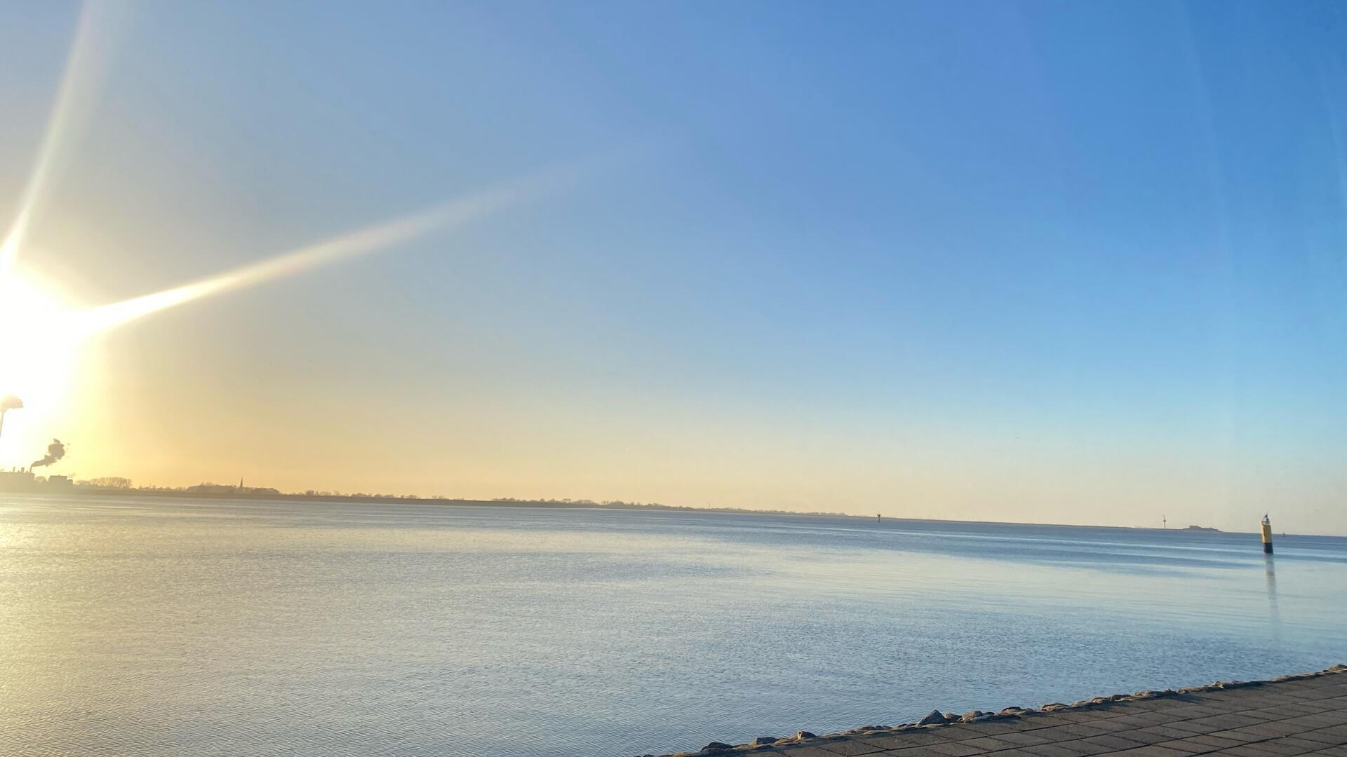 Weiter Horizont, leuchtende frische Luft: Das klare Februarlicht am Deich Bremerhavens lädt zum Schlendern, Nachdenken, Durchatmen, Dankbarsein für solch friedliche Orte und Momente ein.
